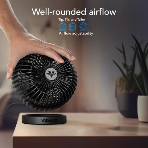 Sphere Personal Adjustable Desk Fan With Quiet Operation and Targeted Cooling Airflow displayed with hand turning it on a desk