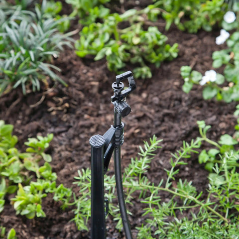 Adjustable Flow Micro Sprinkler With Full Circle Rotary Spray For Drip Irrigation Systems 10-32 Inlet in garden setting