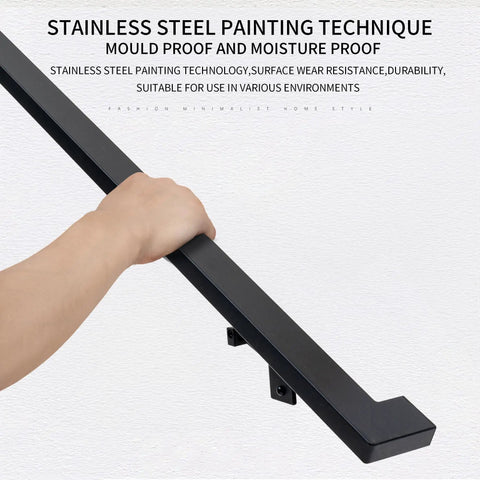 Close view of hand gripping four-foot aluminum handrail kit featuring a matte black finish for stairs and safety.