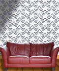 Light Neutral Peel And Stick Wallpaper Roll Heavy Duty Textured Vinyl Self Adhesive Wallcovering No Fuss Room Refresh with geometric pattern behind a red leather couch.
