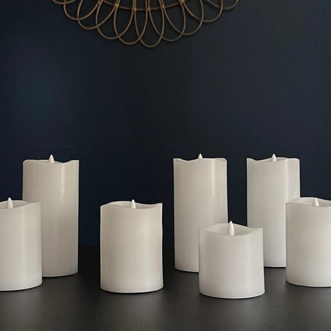 Six Count Real White Wax Flameless LED Pillar Candles 3 By 4 Inches With Remote And Timer Dimmable Flicker on table