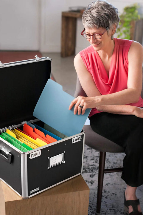 Person using a portable locking file box with dual combination lock for legal and letter size docs, big storage for tax returns.