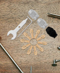 Sixteen Piece Drill Chuck Tool Kit with copper collets, wrenches, and nuts on wooden surface