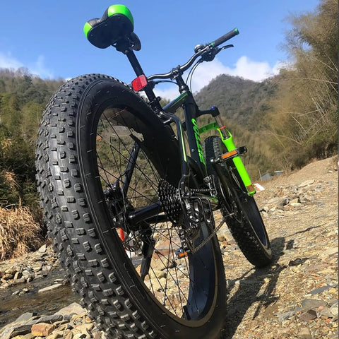 Close-up of an E-bike on rocky trail featuring 20x3.0 Inch Foldable Fat Bike Tire Replacement For E Bike And MTB On Road And Off Road