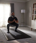 4x8 Gym Flooring Mat For Peloton Bike Elliptical Treadmill And Home Gym Setup Non Slip Floor Pad For Hardwood Or Carpet Just Unroll And Transform Any Room Into A Home Gym Ideal For Spin HIIT Zumba Cardio Training with man exercising
