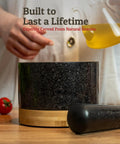 Heavy Duty 100 Percent Natural Granite Mortar And Pestle Set With Bamboo Base 2 Cup Capacity Black Stone Grinder on table