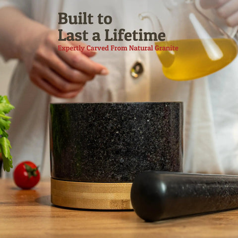 Heavy Duty 100 Percent Natural Granite Mortar And Pestle Set With Bamboo Base 2 Cup Capacity Black Stone Grinder on table