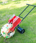 2 In 1 Manual Seeder and Fertilizer Applicator Hand Push Garden Seeder with dual buckets on green grass