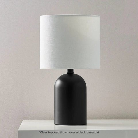 Hella Durable All Surface Clear Topcoat Spray on a black lamp base with white shade, showcasing rust prevention and fade proof defense.