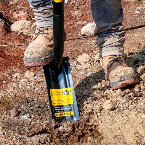 TruPro California Trenching Shovel with 4 Inch 13 Gauge Steel Blade and 48 Inch Fiberglass Handle in use on soil