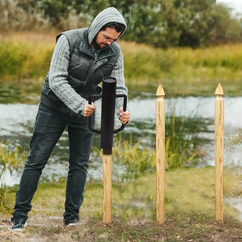 Person using Beefy Heavy Duty Fence Post Driver With Two Handles Steel Head 16.8 Inch T Post Rammer Brown Post Pounder outdoors