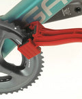 Grunge Brush Bike Chain And Gear Cleaner With Dual Sided Bristles cleaning a bicycle chainring