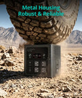 Keep All Your Gear Juiced During Your Latest Adventure With This Hella Reliable Portable Power Station Featuring 640Wh Capacity And 600W Output, robust black power station under tire on rocky terrain.