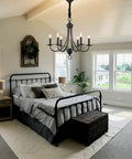 Six Light Black Farmhouse Chandelier With Industrial Modern Vibe Candle Style Hanging Light Fixture in a bedroom setting