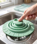 Bekecidi Bathtub Drain Cover, 6-Inch Silicone Tub Stopper, 3 Pack being pressed in a kitchen sink with water droplets.