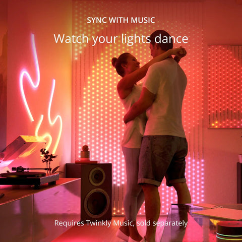 Couple dancing in room with Dots LED String Lights An App Controlled Flexible Color Changing Mood Decor With 60 RGB Segments 200 LEDs Across 33 Feet On Black Wire USB Powered Indoor Smart Home Lighting For Everyday Vibes on wall