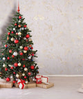 Christmas tree with red and gold ornaments beside textured 3D peel and stick self adhesive wallpaper wall covering