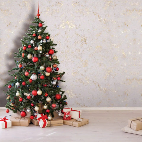 Christmas tree with red and gold ornaments beside textured 3D peel and stick self adhesive wallpaper wall covering