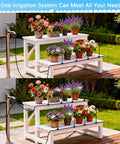 100Ft 360 Degree Adjustable Garden Irrigation System with 18 Nozzles watering potted plants on white benches outdoors