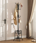 No Fuss Freestanding Coat Rack With 12 Hooks And Umbrella Holder Modern Metal Hall Tree For Entryway Living Room Bedroom Or Office Heavy Duty Standing Coat Hanger Stand In Black with coat and umbrella on hardwood floor.