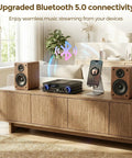 Living room setup with Beefy 2.1 Channel Home Audio Amplifier With Bluetooth 5.0 USB And AUX Remote Bass Treble And Sub Control between two speakers.