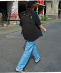 Person walking with a 12 Inch Practice Snare Drum Bag Built Like A Tank With No Sweat Waterproof Oxford Cloth Easy Carry Adjustable Strap.