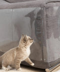 Grey sofa with Bed Skirt Twist Pins with Clear Heads for Upholstery and Slipcovers keeps fabric in place, shown with a curious cat