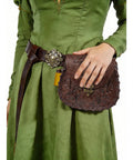 Vintage Brown Faux Leather Medieval Belt Pouch Featuring Carved Elven Leaf Details worn on green dress, showing intricate design and belt.