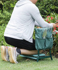 Person using Garden Kneeler Seat With EVA Foam Cushion And Steel Frame Tool Pouch Foldable Grab And Go Portable Bench Kneeling Pad in garden