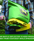 Man using 25 Lb Handheld Bag Seeder Spreader With Waterproof Vinyl Bag, Enclosed Gears, Adjustable Shoulder Strap outdoors