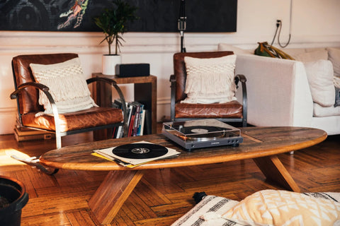 Front view of AT-LPGO-BT belt-drive wireless turntable (gun-metal) with open dust cover on a coffee table.