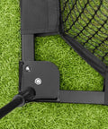 Spacious 8 Foot Pop Up Golf Cage For Home Practice corner frame detail with durable 3 ply net on green grass surface