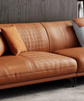 Heavy Duty Leather Repair Tape Kit That Delivers A Dang Sure Fix Easy Peel And Stick Couch Patches For Scratches Scuffs And Tears No Sew Brown 8.2 By 11 Inch 2 Pack applied on a brown leather couch.