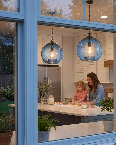 CASAMOTION Modern Farmhouse Blue Glass Globe Pendant Light 11" Dia hanging in kitchen above mother and daughter baking.
