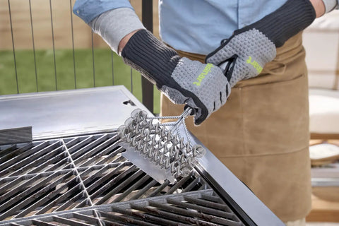 Person using Triple Coil Grill Brush 17 Inch Stainless Steel Bristle Free Scraper For All Grates With Flexible Coils on BBQ grill