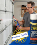 Man using Heavy Duty Garage Door Lubricant 20 Oz Long Lasting Multi Purpose Rust Preventative Water Resistant Lube For Springs Rollers Hinges And Locks Keeps Your Garage Door Quiet Smooth And Ready For Any Season on a garage door.