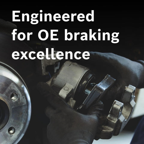 Bosch BC606 QuietCast ceramic brake pads, rear; installed on brake rotor with gloved hands.