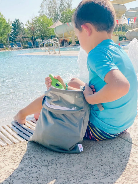 Child by the pool using 2 Pack Cloth Diaper Wet Dry Bags Waterproof Reusable With Dual Zip Pockets For Travel Beach Pool Daycare Soiled Baby Items Gym Bag For Swimsuits Or Wet Clothes