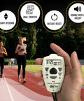 Slick Dual Display Electronic Tally Counter With Quick Add Subtract Thumb Clicker Design Killer For Golf Pitches Lap Timing And Weekend Sports Rallies held by a person while runners jog on a track.