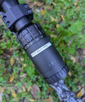 Close-up of a rifle scope with the Vinyl Rifle Scope Turret Labels Kit With 25 Yard Increments From 100 To 1000 Yards Range Day Ready