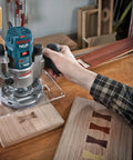 Person using RBS006TES 6 Piece Carbide Tipped Trim and Edging Router Bit Set for precise finishing on wood panel