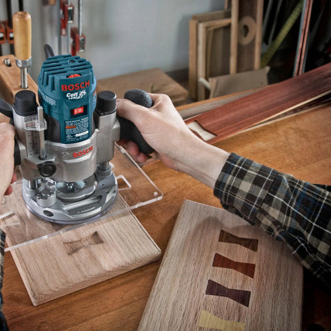 Close-up of hands using Bosch router on wood with Six Piece Universal Groove Cutter Router Bit Set With Carbide Tips for grooving