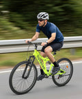 Cyclist riding 26 Inch Mountain Bike For Men And Women Of All Ages With 7 Speed Drivetrain, Aviation Grade High Carbon Steel Frame, Green
