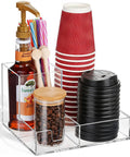 Clear Acrylic Coffee Cup Holder For Countertop With Three Compartments For Cups Lids Straws Pods Sugar Packets And Tea Bags A Handy Coffee Bar Organizer For Kitchen Counters showing cups, lids, straws, syrup, and coffee beans.
