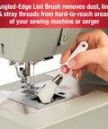 Person using angled lint brush from 7 Piece Sewing Machine Maintenance Tool Kit With Needle Inserter, Angled Lint Brush, Threader And 3 Screwdrivers, Universal Compatibility, Handy Storage Pouch, Quick Home Sewing Repairs For Any Project on a sewing machine