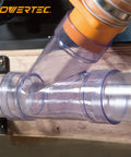 Drop Dead Easy Two And A Half Inch Dust Collection Fitting Network Kit With Five Swing Out Blast Gates Three Foot Duct Pipes Y Branches And Ninety Degree Elbows For Zero Mess Woodshop Cleanups connection fitting in clear plastic with wood background.