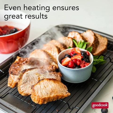 Nonstick 15 X 10.5 Inch Baking Pan With Raised Wire Rack For Crispy Bacon, Chicken And Fries, showing cooked meat and fruit.