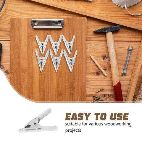 Cool 12 Piece Heavy Duty Metal Spring Clamp Kit For Woodworking, DIY Crafts And Clothesline Hanging With White Plastic Coating Tough Aframe Clips That Are Super Durable And Ready To Slam Home. Metal spring clamps on a bamboo board for woodworking