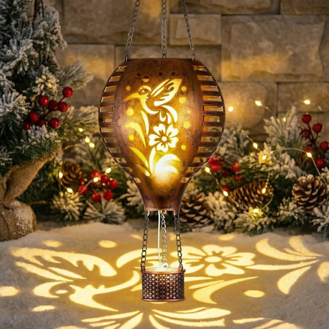 Hummingbird Hot Air Balloon Hanging Solar Lantern 1 Pack For Garden Decor Ten Point Six Inch Outdoor Lights glowing at night