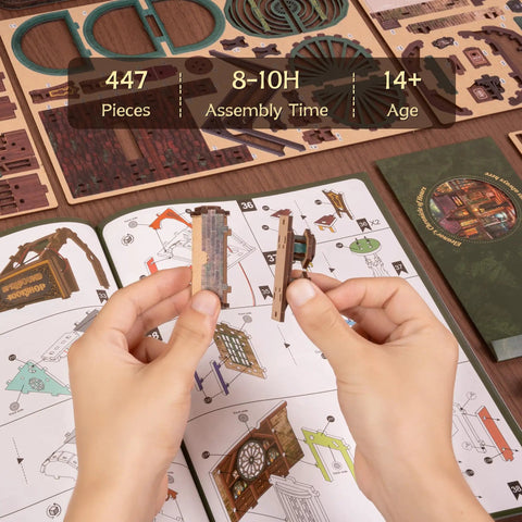Hands assembling 3D Wooden Puzzle Bookstore With LED Lights Spellbound Miniature Kit, DIY home decor, instruction manual visible.